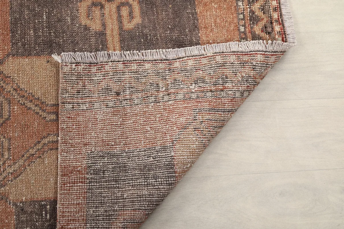 Another view of the folded corner, showing more of the rug's sturdy cotton foundation and construction