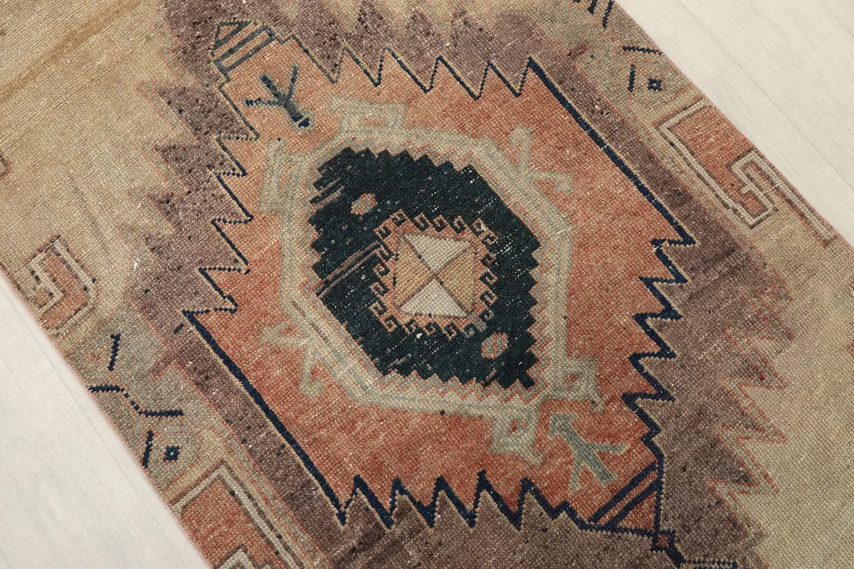 Close-up of a central geometric medallion, revealing the intricate tribal patterns and colors