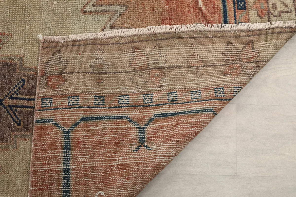 Close-up of the rug's back, showing the consistent knotting and structure of the vintage piece