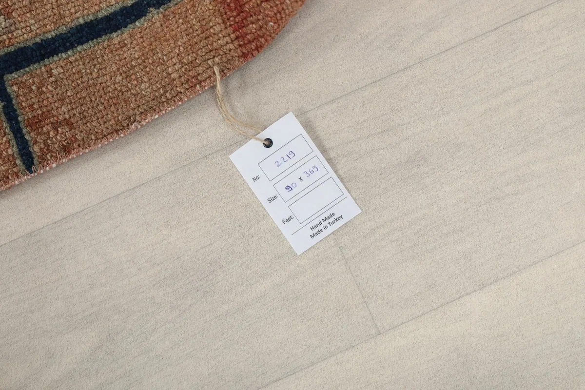 Product tag attached to the rug, displaying item number, size in cm, and 'Hand Made in Turkey'