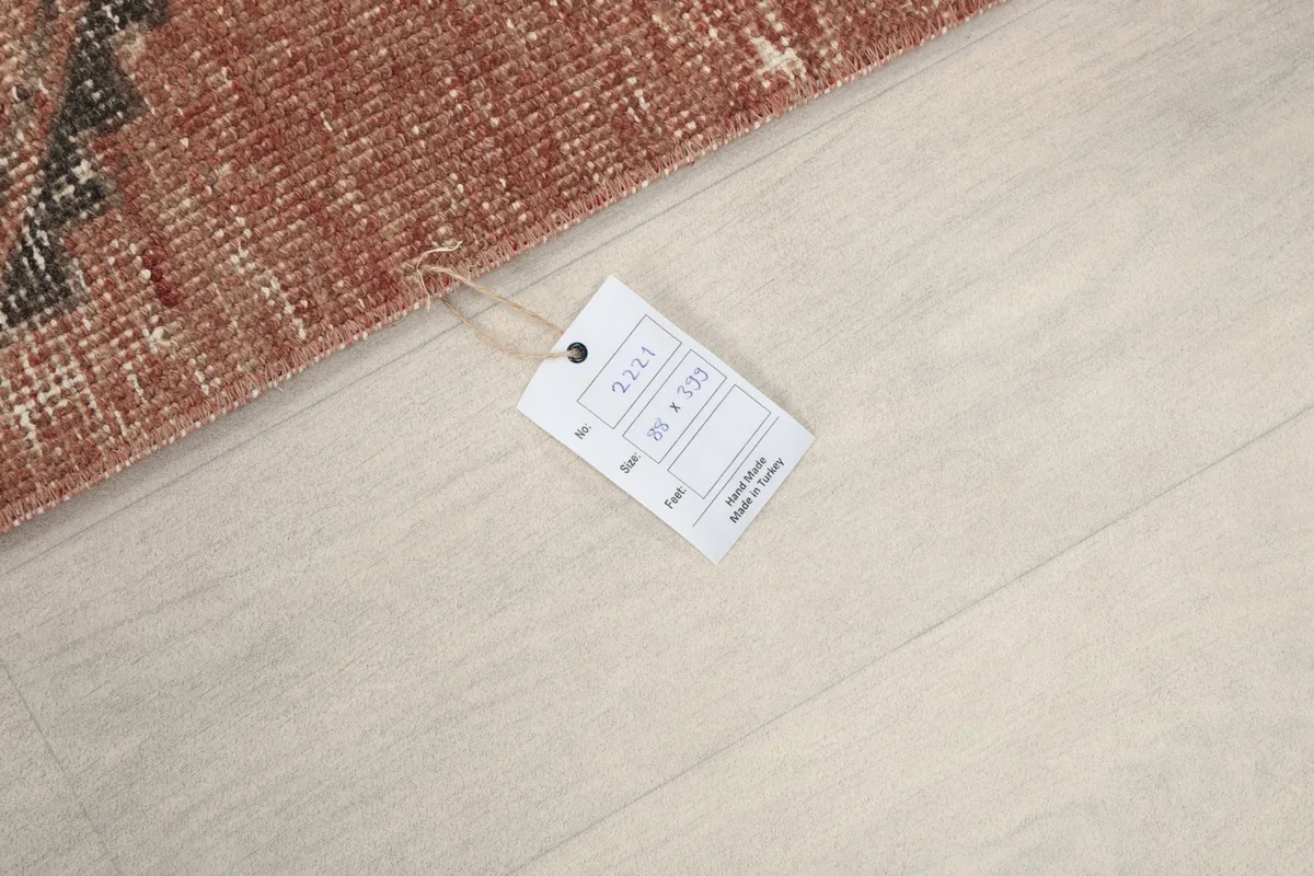 Close-up of the rug's tag displaying size information and origin