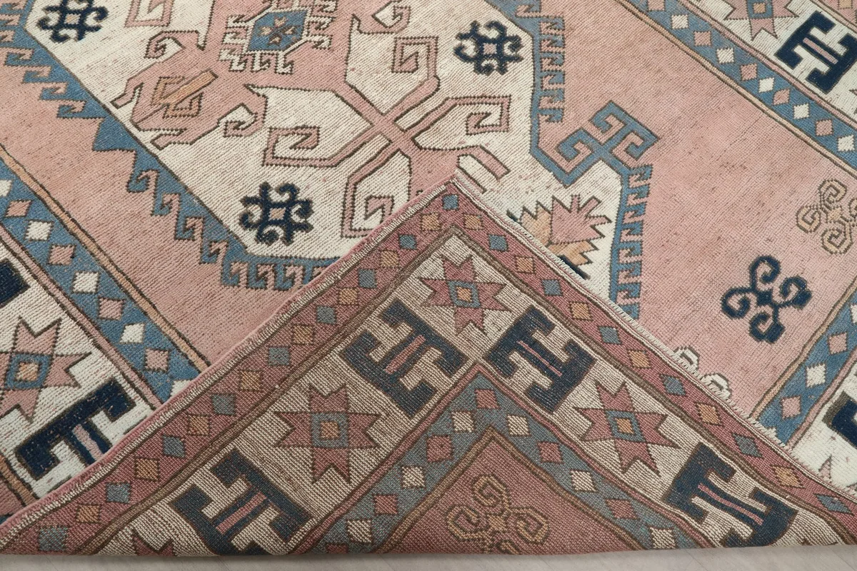 Folded corner of the rug showing the reverse side of the hand-knotted wool and cotton foundation