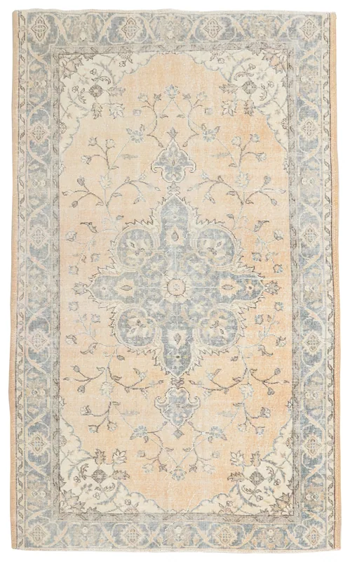 Full top view of the beige and gray floral medallion area rug on a white background