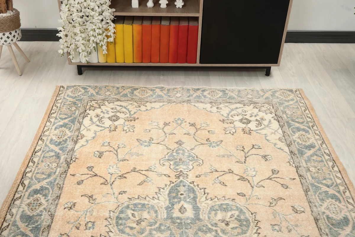 Front view of the rug in a living room, highlighting the central medallion and overall pattern