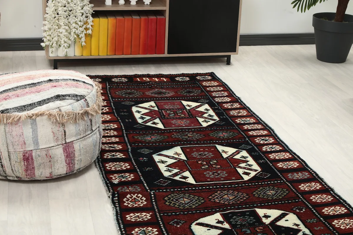 Close-up angle view of the runner rug showing its geometric patterns and colors in a room