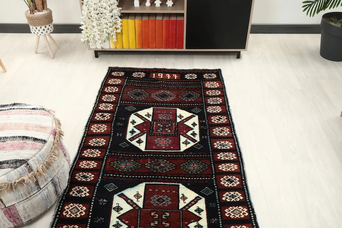 Overhead view of the rug in a room, showing its length and the pattern repetition