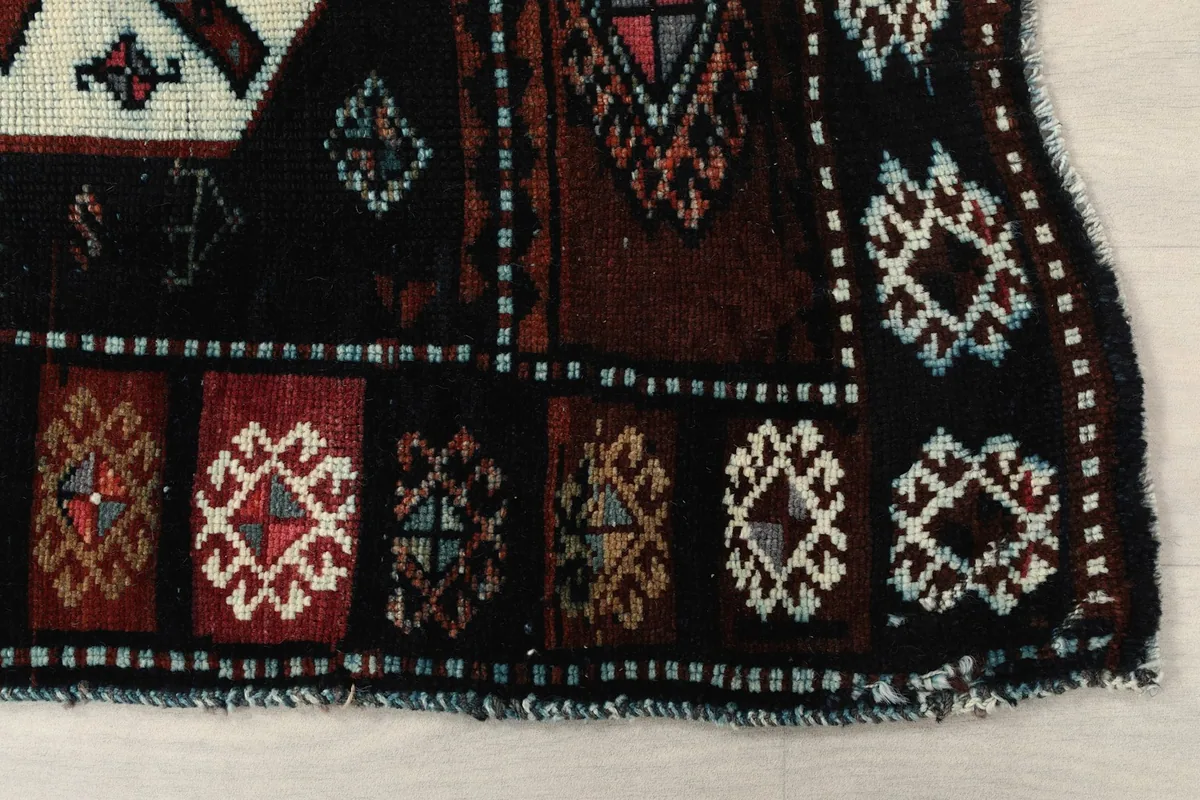 Detailed view of the end of the runner rug, showing the border and subtle fringe