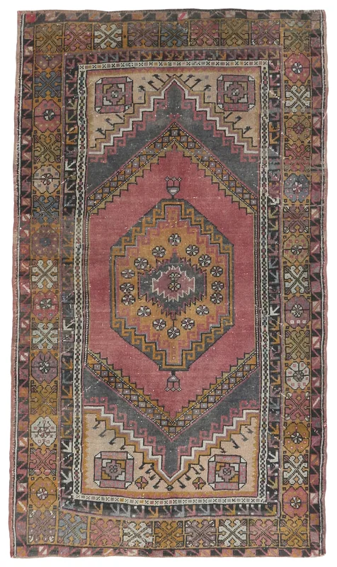 Full top view of the vintage rose and gold geometric medallion rug on a white background.