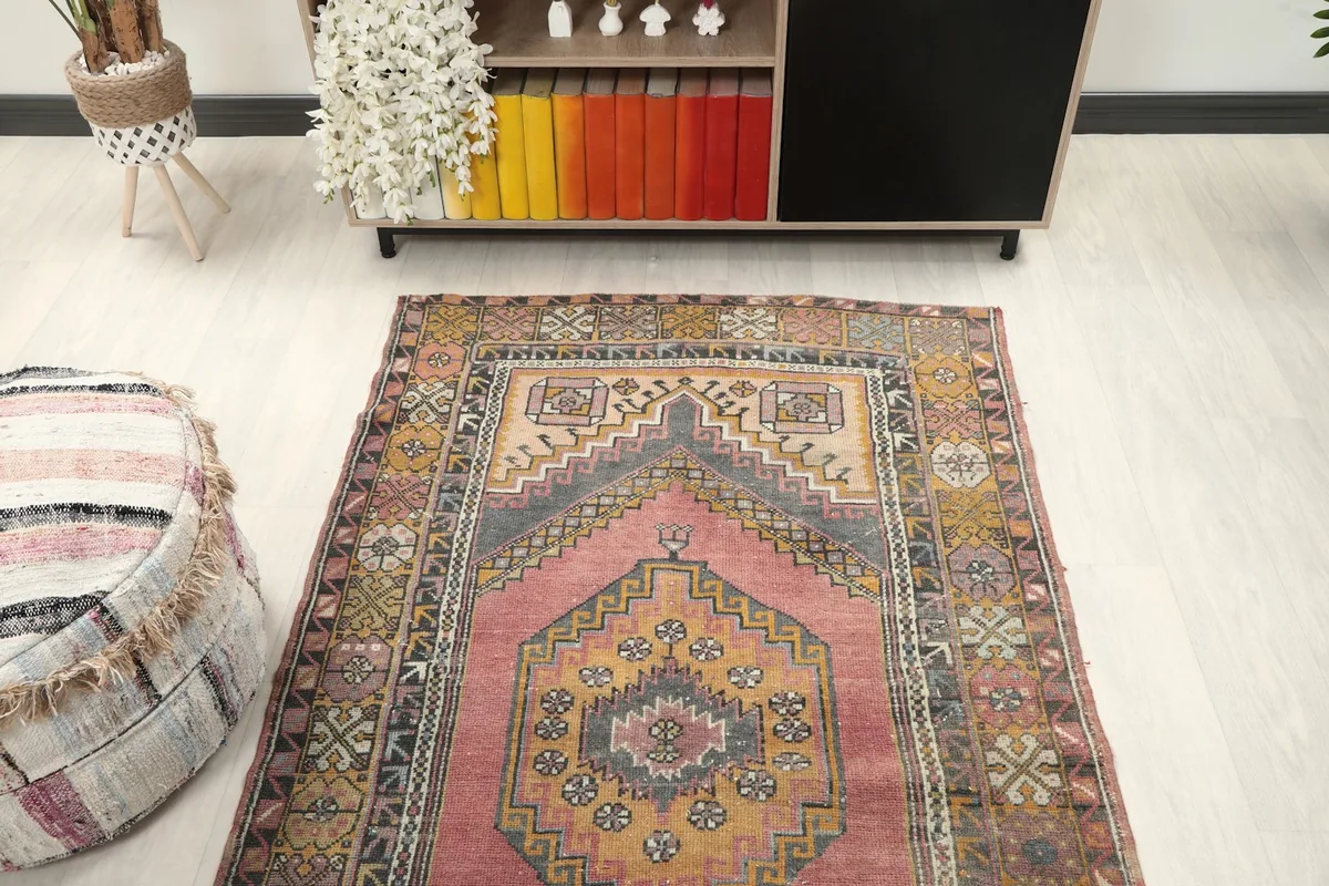 Overhead view of the rug in a room, showing the full design and surrounding decor.