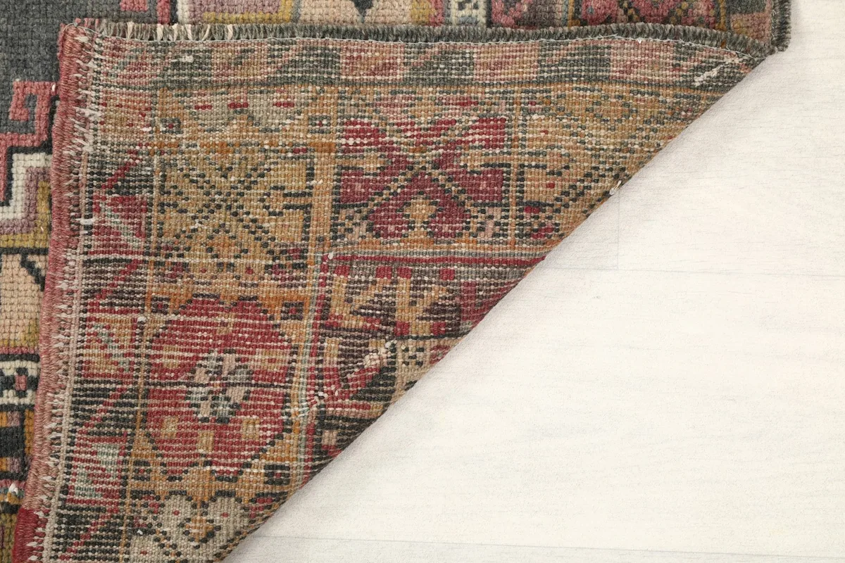 View of the rug's back, showcasing the tightly woven hand-knotted structure and foundation.