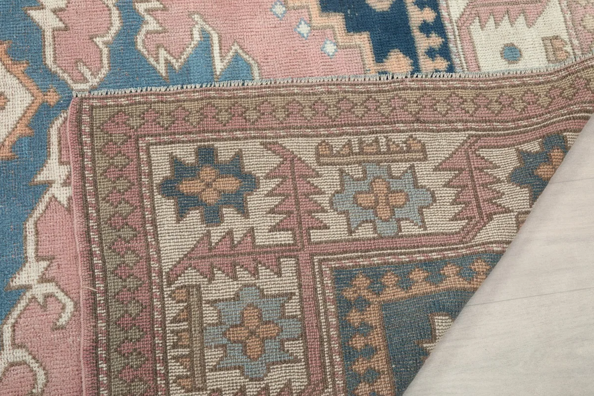 Close-up of the reverse side of the rug, showing the tightly woven cotton foundation and knotting.