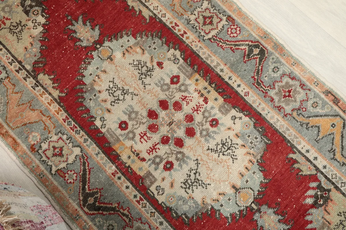 Angled view highlighting the central red medallion and the rug's overall design