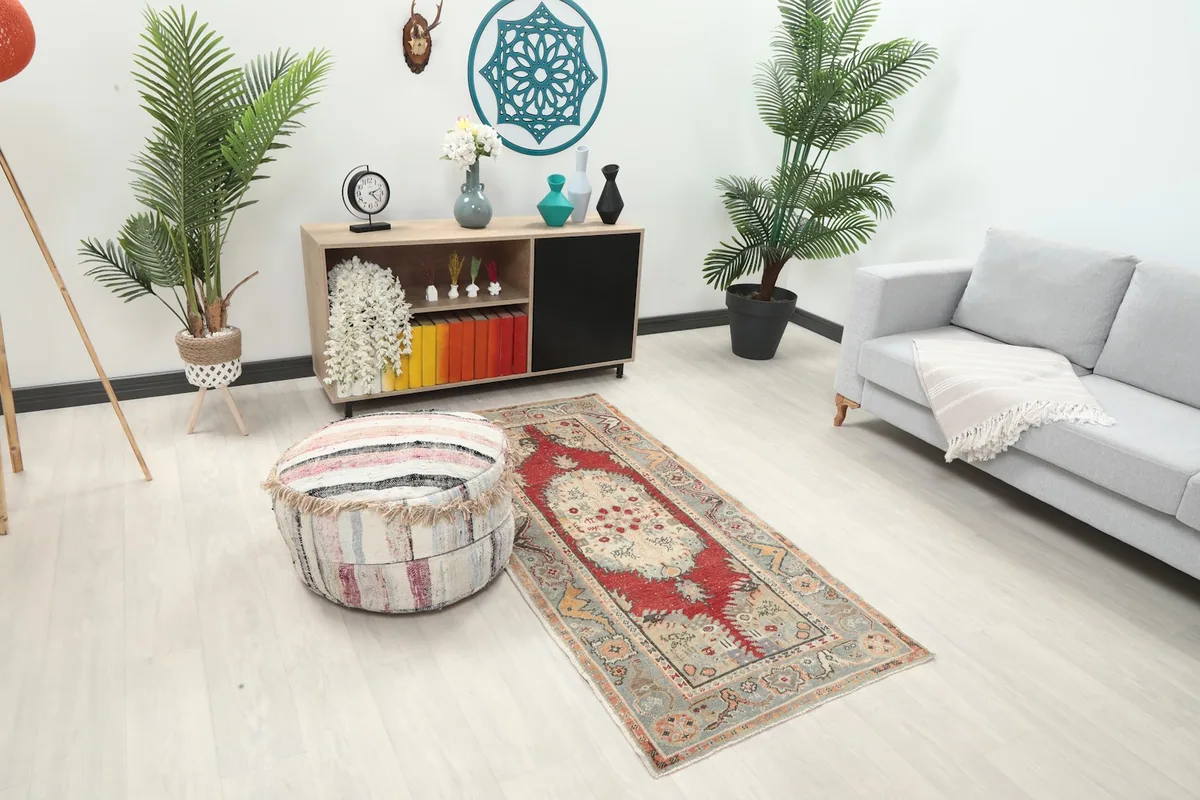 Overhead view of the red and beige rug placed in a modern living space