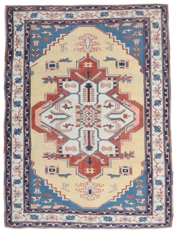 Full top view of the beige and blue vintage Anatolian rug with a central rust and ivory medallion