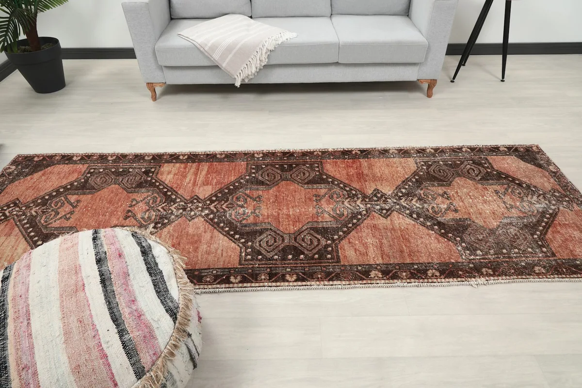 Full length view of the runner rug extending across a room, from a slightly elevated perspective.