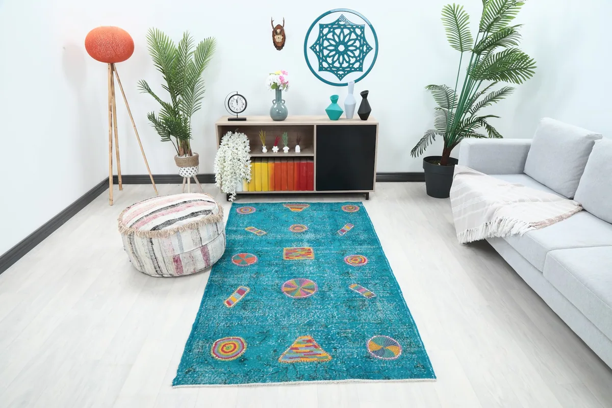Vintage blue multicolor geometric rug displayed in a modern living room setting.