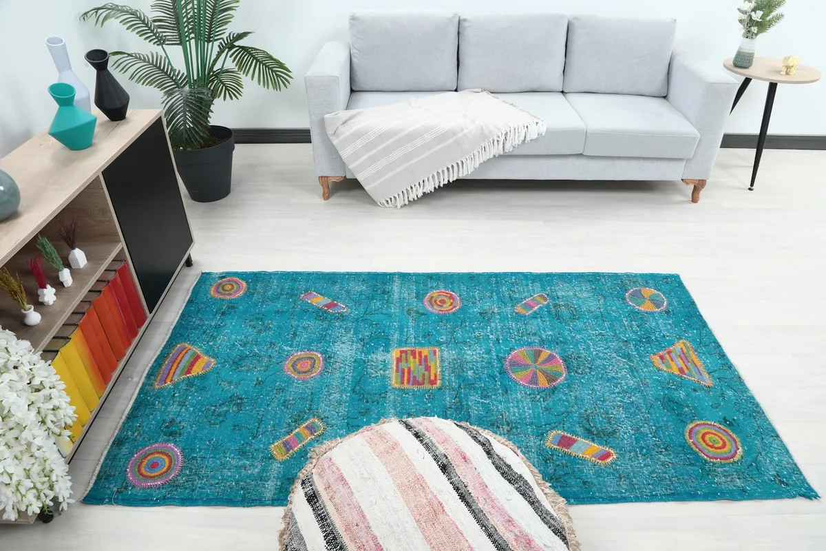 Full room view with the blue multicolor rug as a focal point in a bright living area.