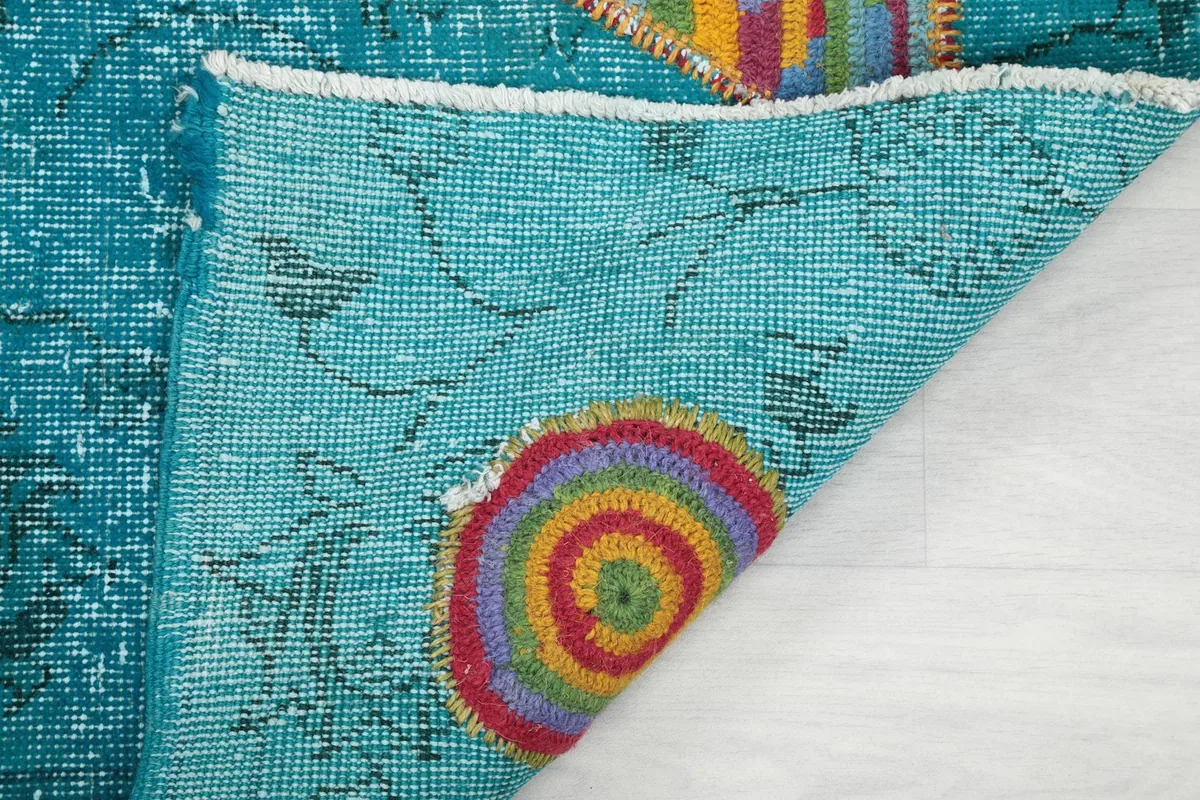Close-up of the back of the hand-knotted wool rug, revealing its construction.