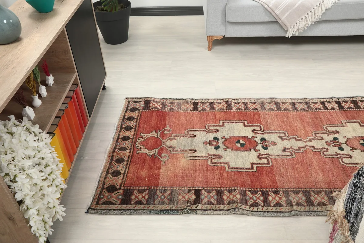Side view of the runner rug stretching along a hallway next to furniture