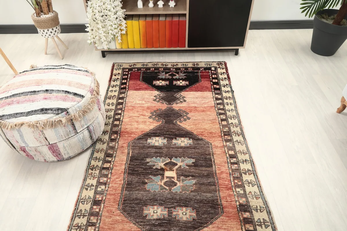 Overhead view of the runner rug in a room setting, highlighting its long, narrow shape.