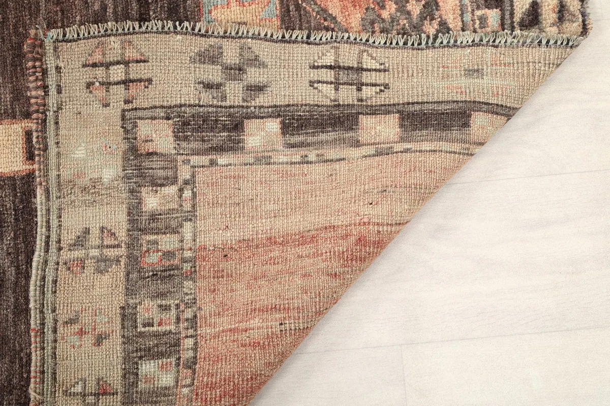Close-up of the low wool pile and the hand-knotted construction of the runner.