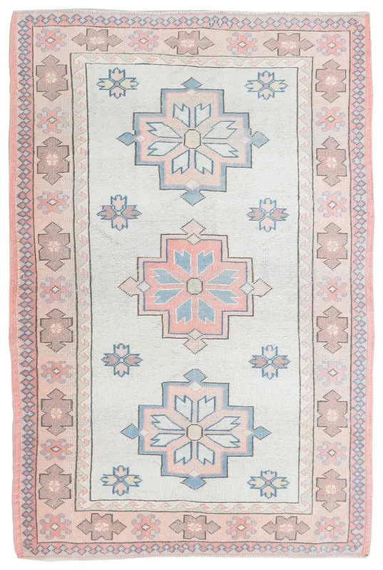 Full top view of the vintage Anatolian rug with ivory field and rose, blue tribal motifs