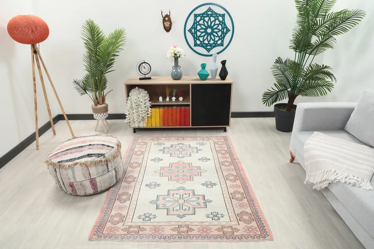 Vintage Anatolian rug displayed in a room setting with minimalist furniture and plants