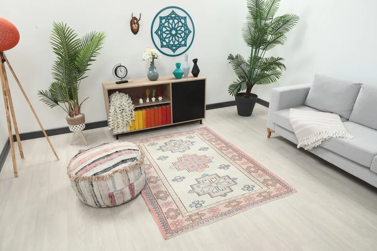 Another room view of the vintage ivory and rose tribal rug, showing its placement in a modern space