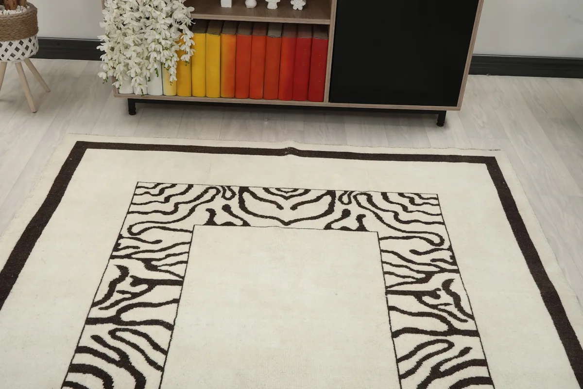 Overhead angled shot focusing on the central cream panel and the charcoal inner frame