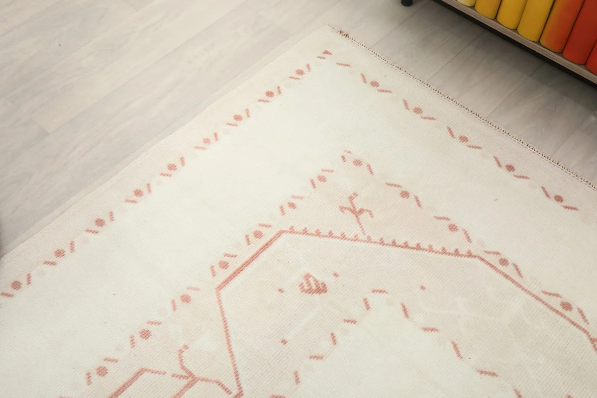 Corner detail of the rug showing the intricate geometric patterns and border