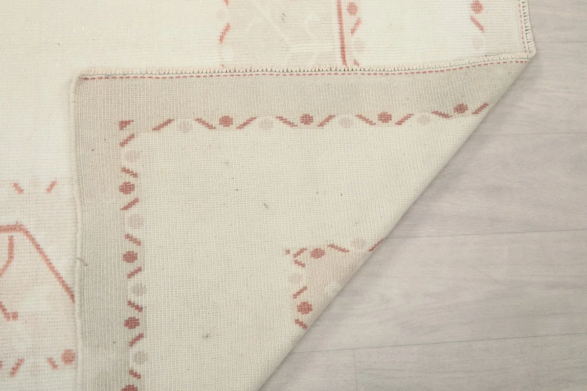 Underside view of a folded corner of the rug, revealing the tight knotting