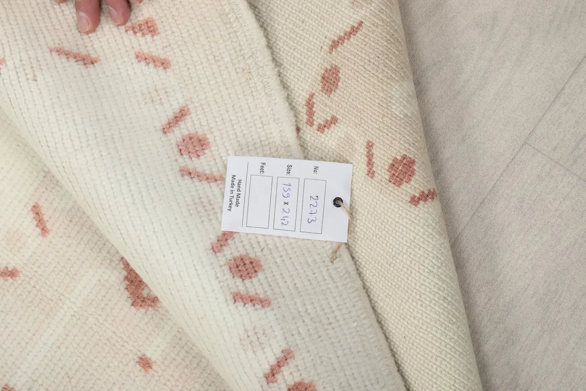Label attached to the rug, showing its dimensions 159x242 cm and item number