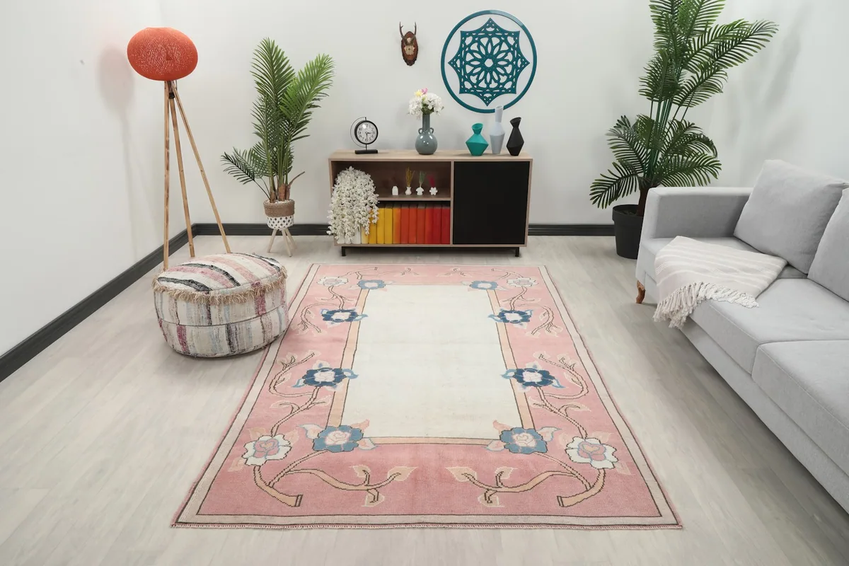 Vintage Anatolian rug in a living room setting with a gray sofa and wooden furniture