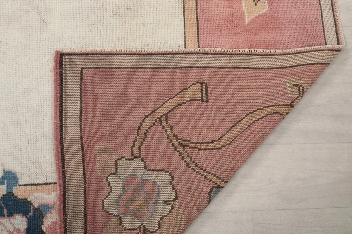 Another view of the rug's corner folded, displaying the back of the weave