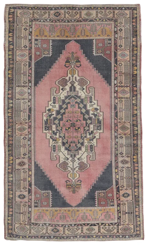 Full top view of the 4'9" x 8'1" rose and navy vintage Anatolian area rug