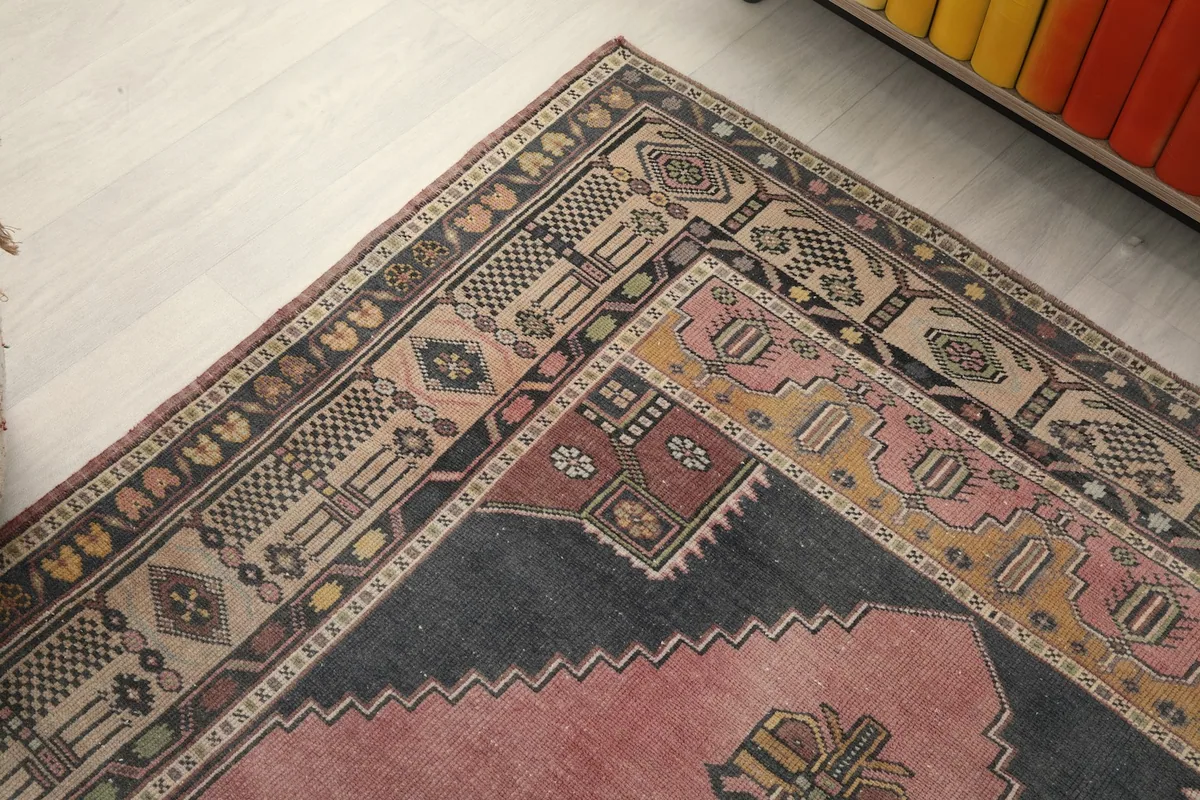 Corner detail of the rug, highlighting the various geometric motifs and color variations