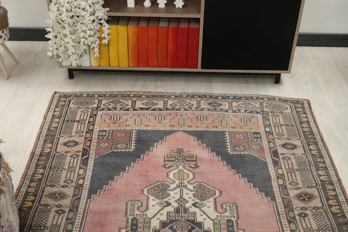 Overhead view of the vintage rug in a room, showing its placement relative to a console
