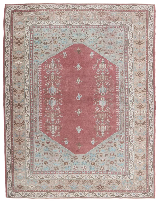 Full overhead view of the vintage rose Anatolian tribal medallion rug on a white background