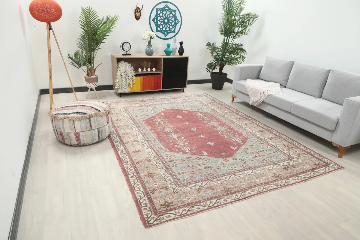 Angle view of the rose Anatolian rug in a living room, showing its full size and colors