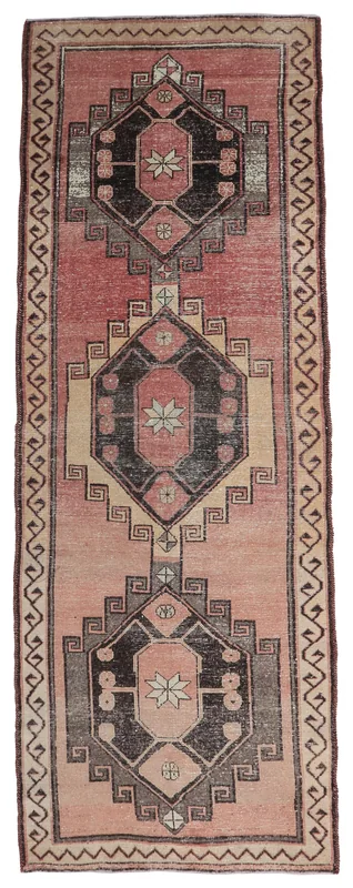Full overhead view of the 4x12 rose and black tribal geometric runner rug on a white background.