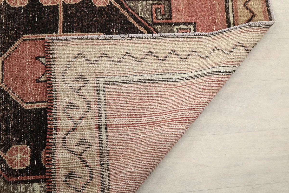 Another view of the rug's backside, showing the tight knotting and craftsmanship of the vintage piece.
