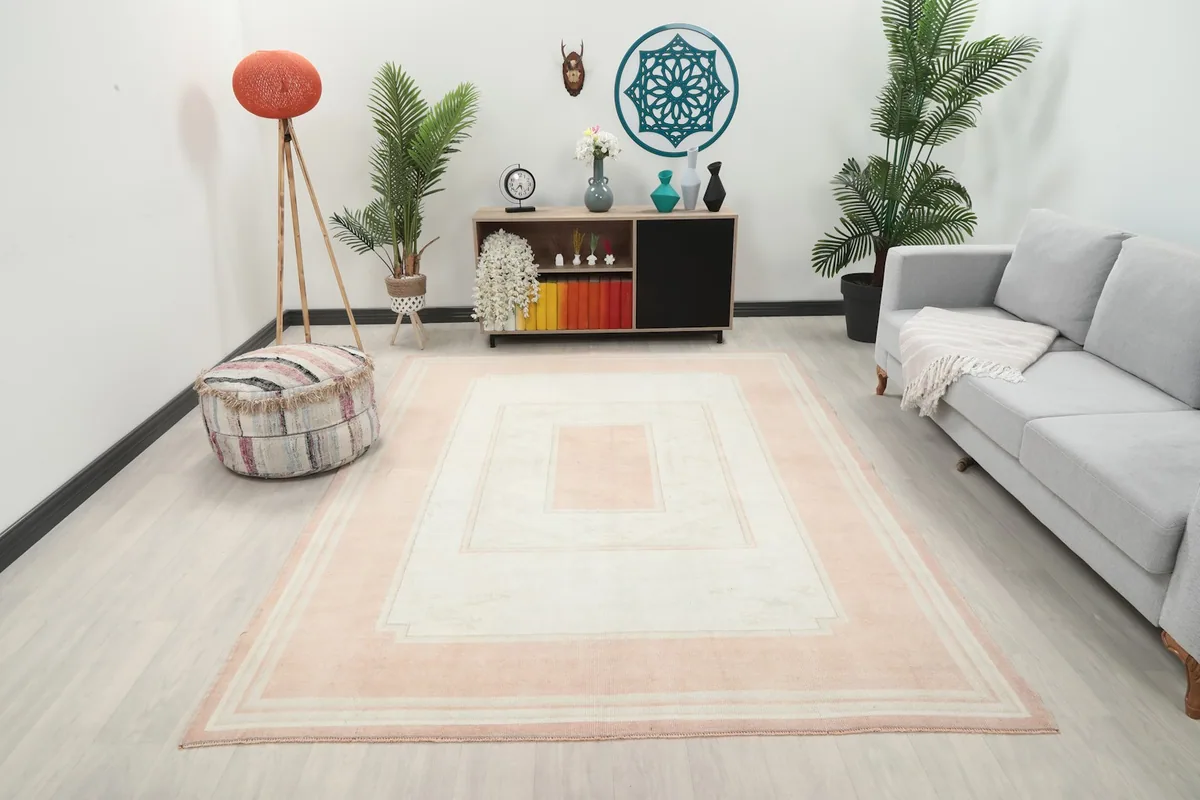 Vintage pink and ivory rug showcased in a modern living room setting