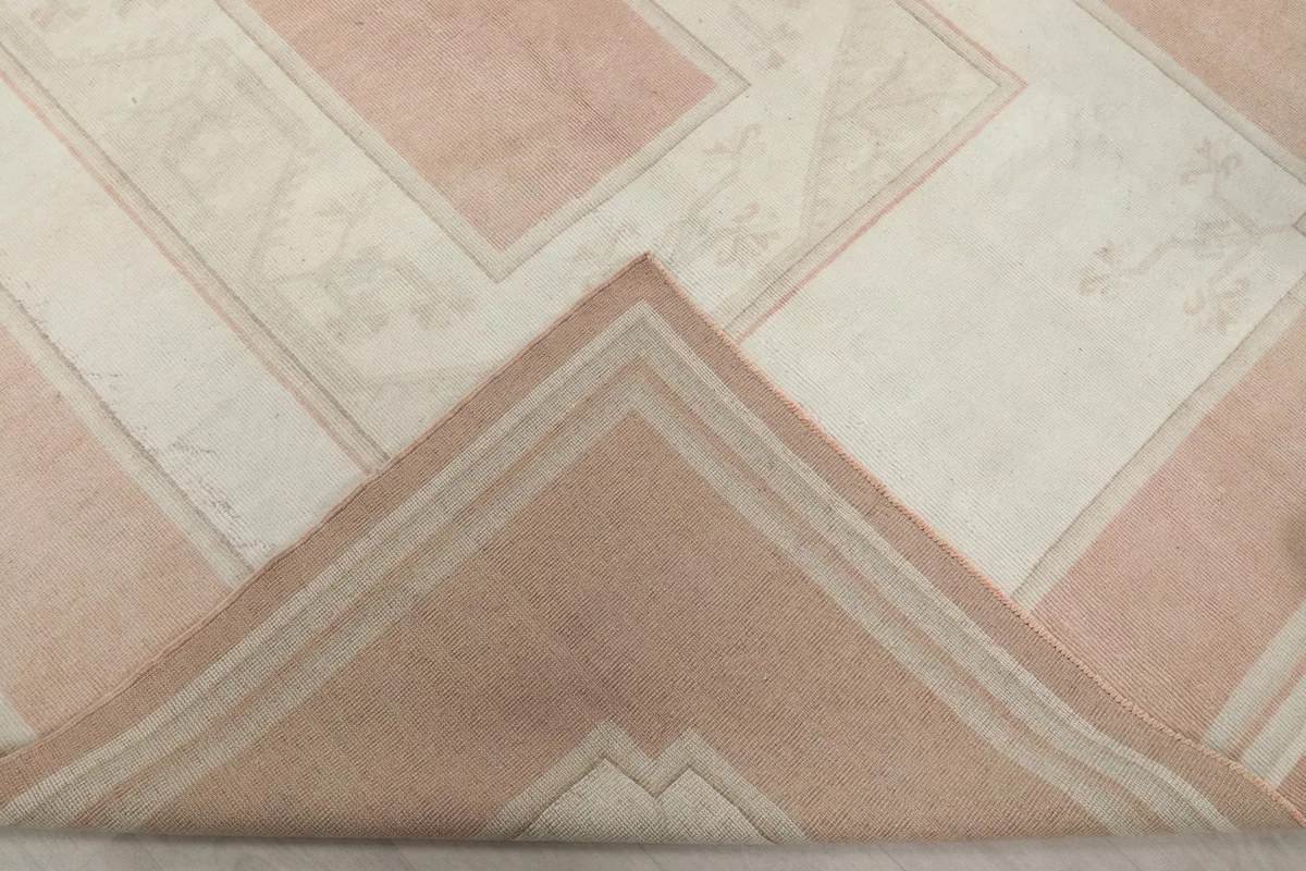 Folded corner of the rug revealing the thickness and construction of the wool pile