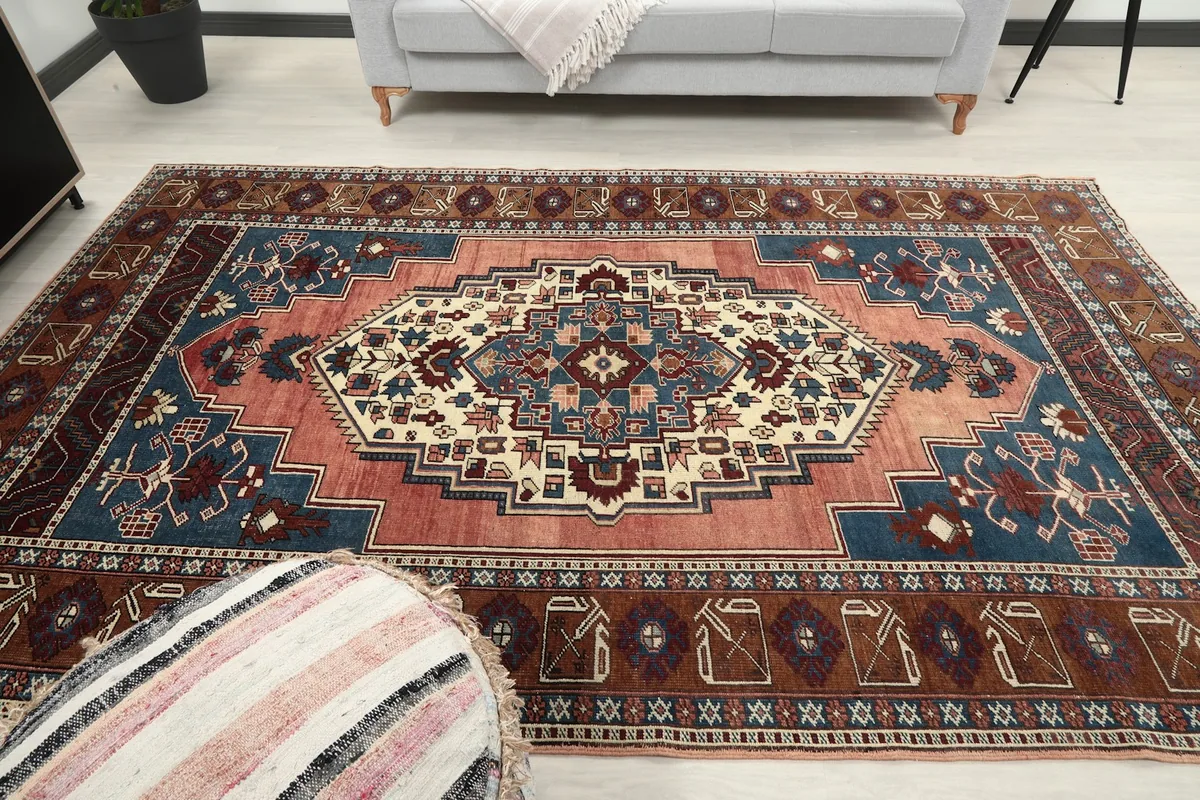 Front view of the rug in a room setting, with a sofa and decorative elements