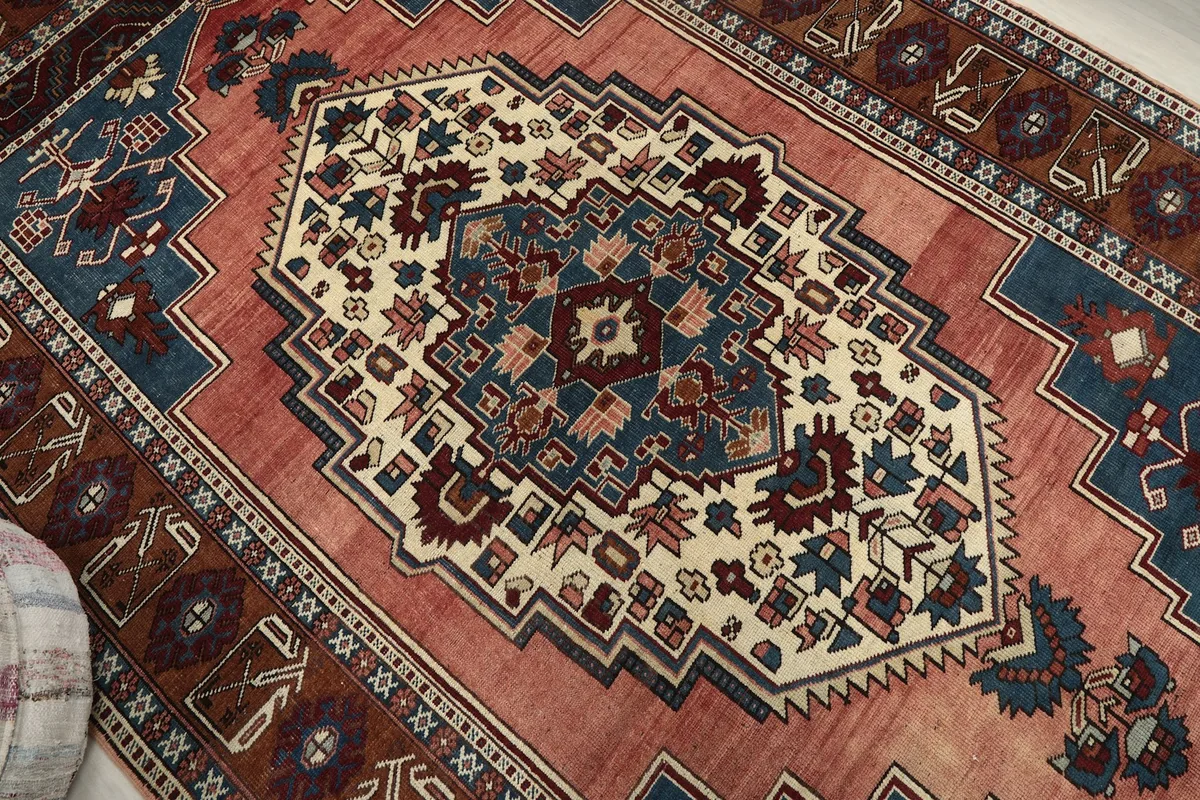 Close-up of the central medallion with cream, navy, and red tribal designs