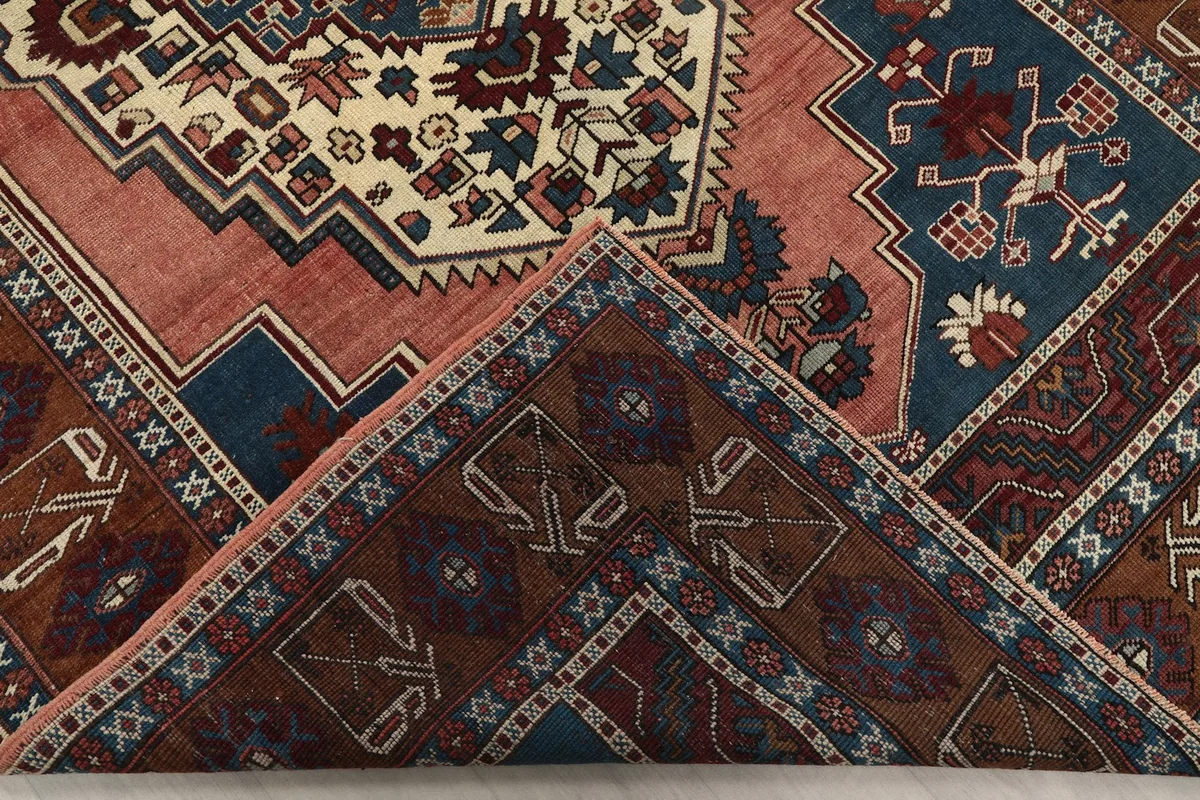 Folded corner of the rug, showing the reverse side and knotting detail