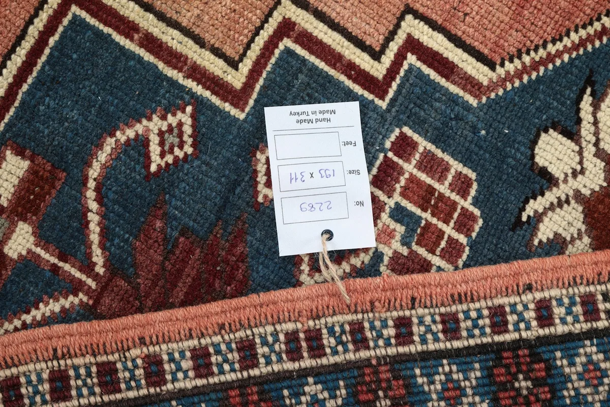 Care tag on the back of the rug, indicating dimensions and origin