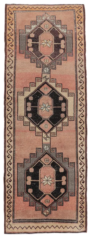 Full overhead view of the 4'4" x 12'4" rose geometric Anatolian runner rug on a white background.