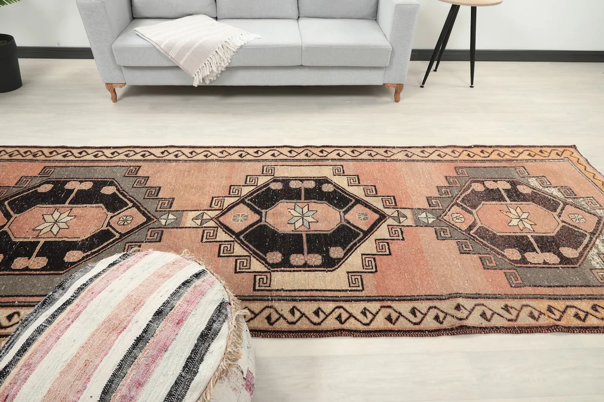 Another angle showing the rose runner rug in a hallway, leading to a living area.
