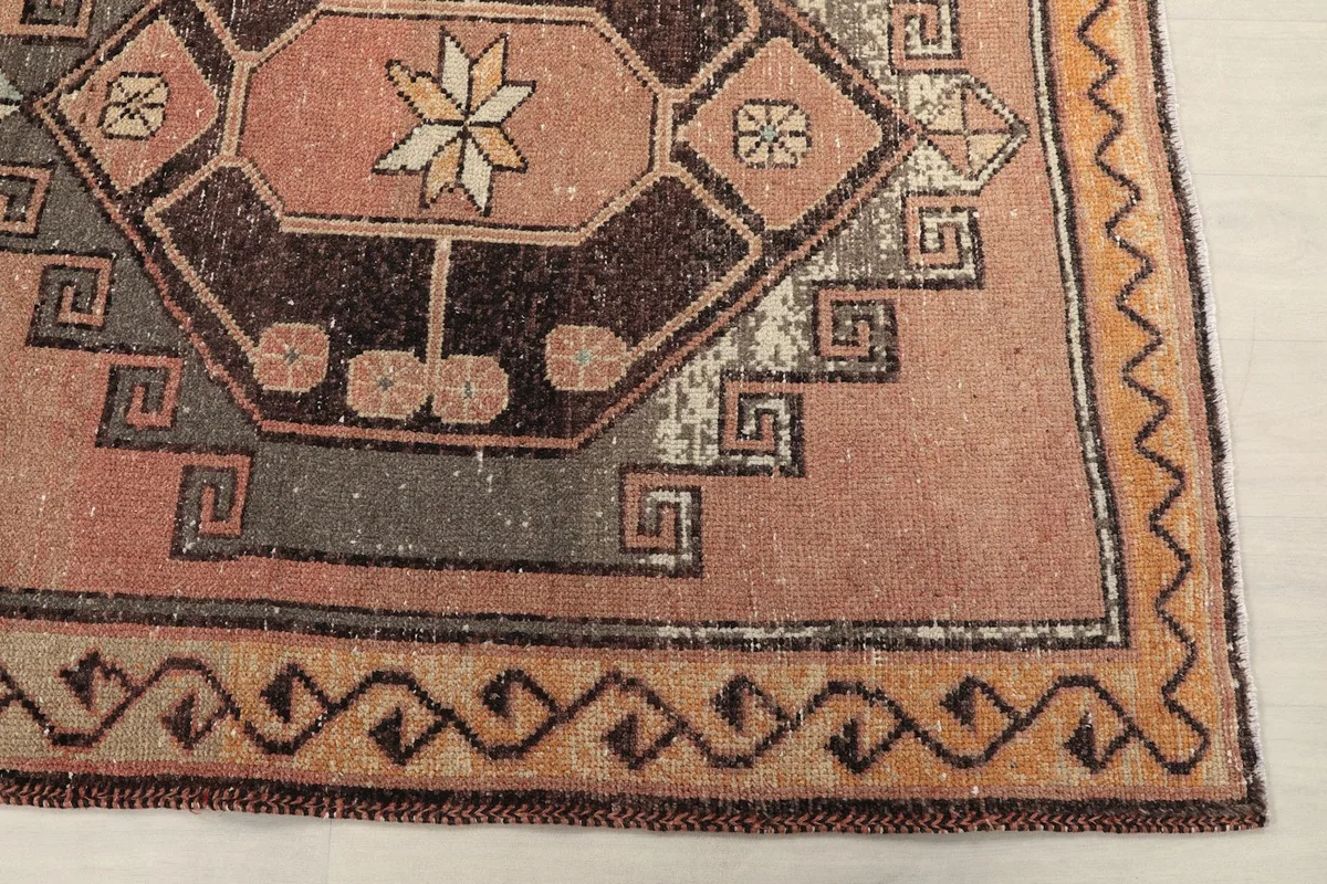 Detailed view of the rose field and geometric border pattern.